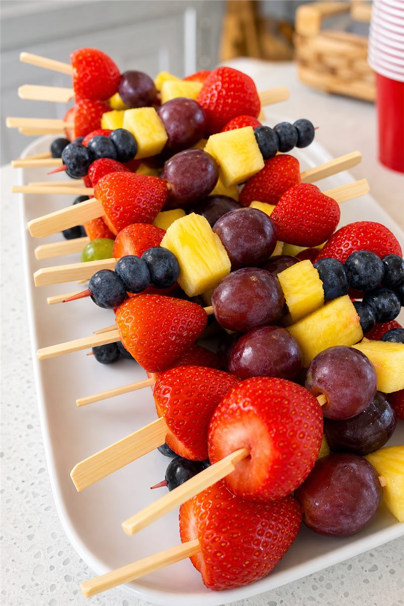 Fresh fruit skewers arranged for a children's party.