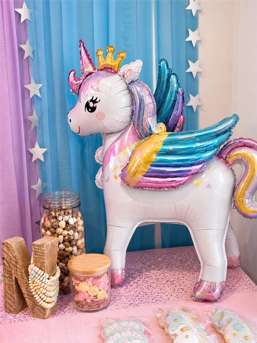 Close-up of pastel unicorn party balloons and themed decorations.