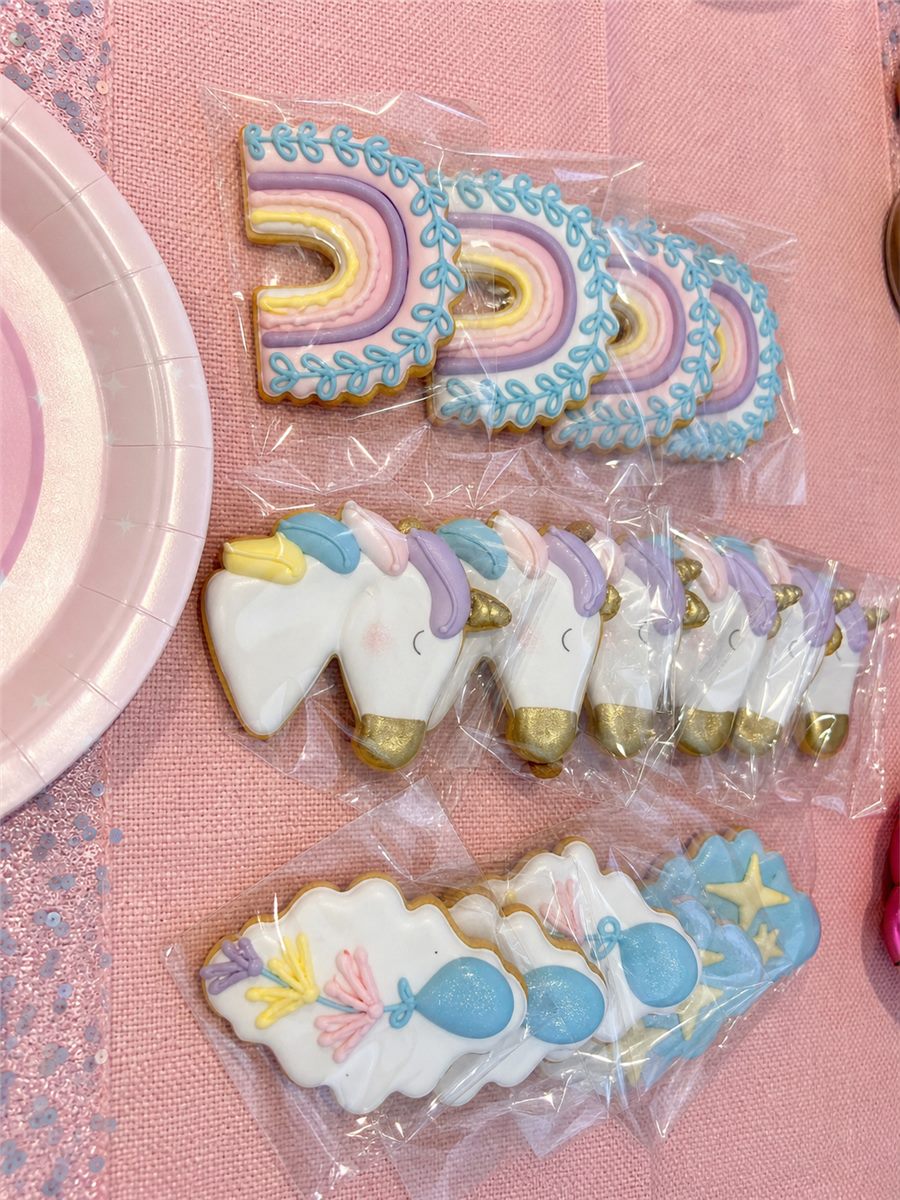 Unicorn themed decorated cookie favours in clear bags.